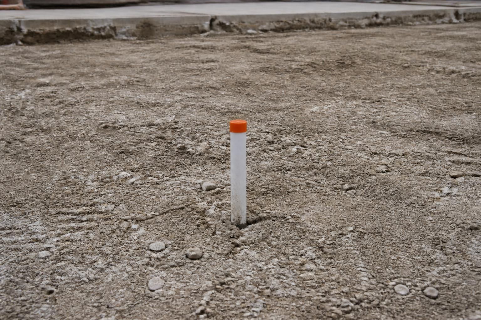 Cleared concrete demolition site prepared for new construction.