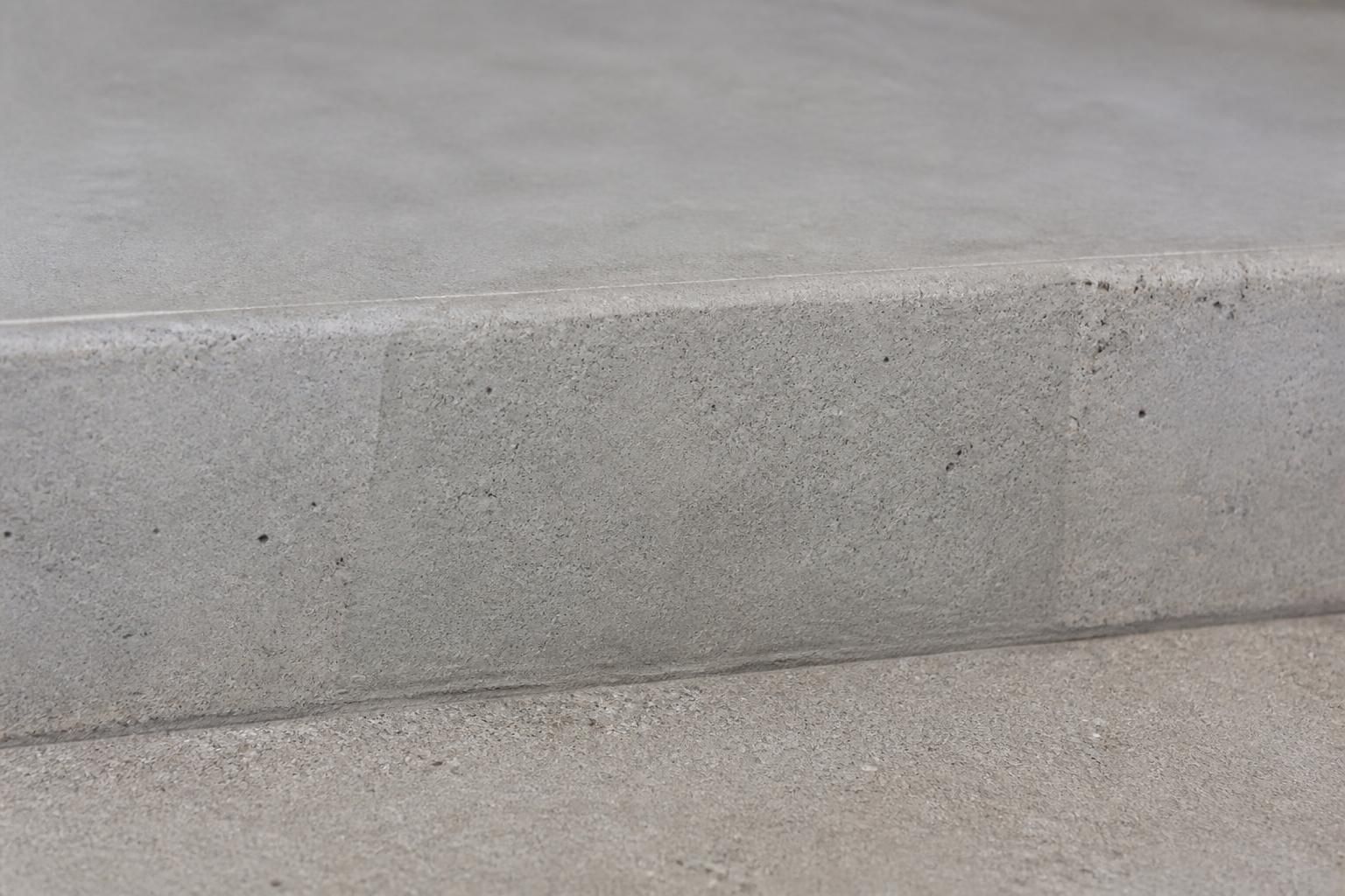 Repaired concrete surface with a smooth restored finish.