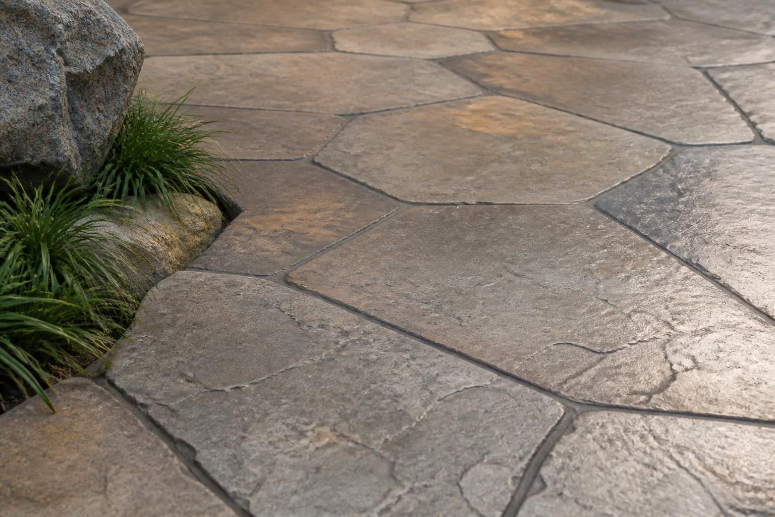 Stamped concrete with a refined stone-like pattern and natural tones.